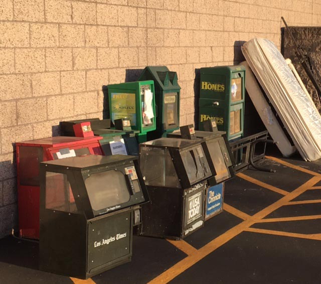 Print newspaper racks sit next to a dumpster behind the Albertson's grocery store in Paso Robles. The shopping center management had given the publications notice to remove the racks by May 31.